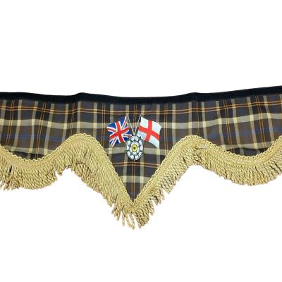 A premium truck pelmet featuring Union Jack and St George flags with a Yorkshire rose emblem on a tartan background, finished with thisck gold bullion trim. Whiterig Truck Curtains